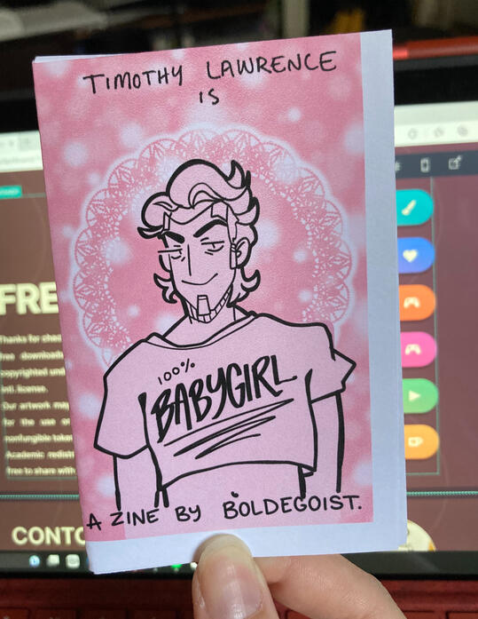 A folded zine that reads "TIMOTHY LAWRENCE is 100% BABYGIRL"